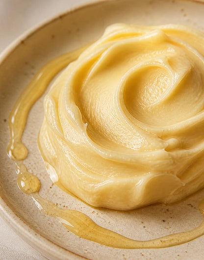 Macro texture of whipped tallow honey balm with raw honey drizzle